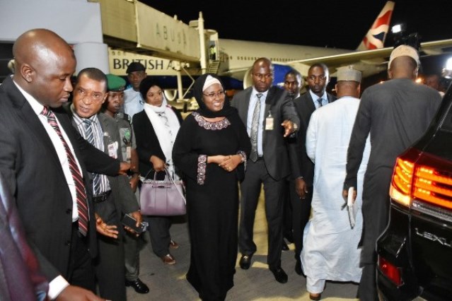 Aisha returns from UK, says President is recuperating fast